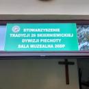 Drzwi wejściowe z napisem u góry o Stowarzyszeniu i Tradycji 26 Skierniewickiej Dywizji Piechoty